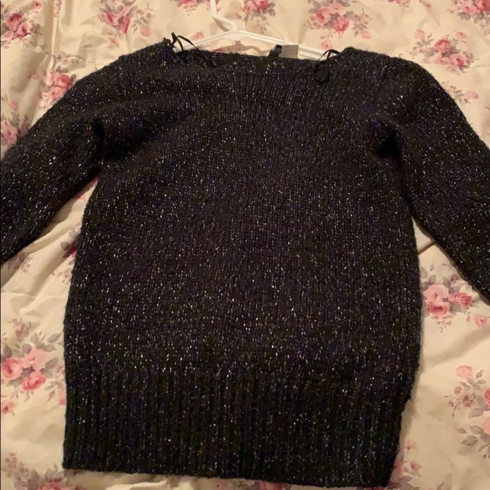 Black sweater with metallic detail.